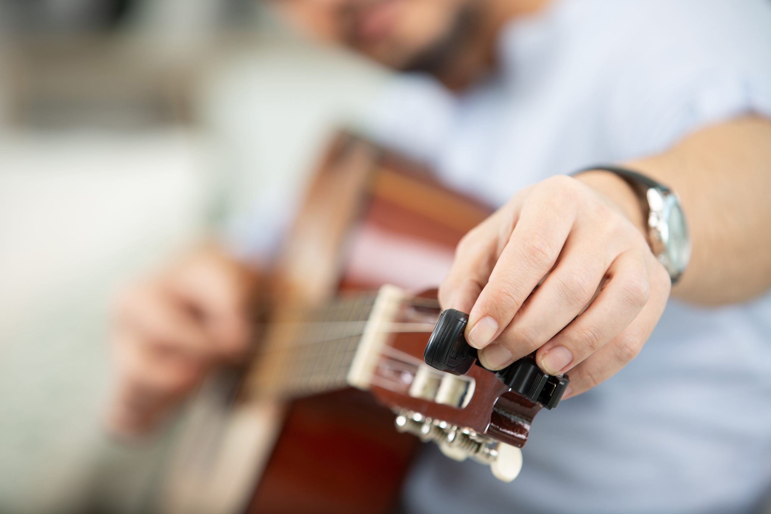close up of man playing classical guitar